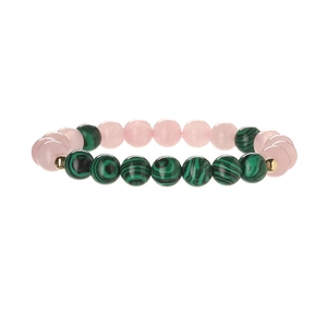 Close-up of pink quartz and green malachite beads on a natural stone bracelet