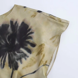 Detail of floral print satin dress featuring round neck and sleeveless design