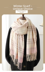Close-up of pink and grey plaid cashmere-feel scarf with long fringe tassel details