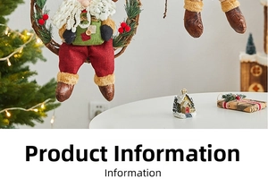 Detail of Christmas wreath with Santa Claus doll beside a miniature snowy cottage and gift box