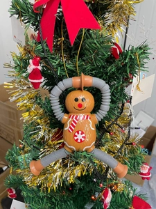 Gingerbread man telescopic tube toy with suction cups hanging on a Christmas tree