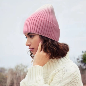 Women's winter ribbed knit beanie featuring pink and white gradient color design