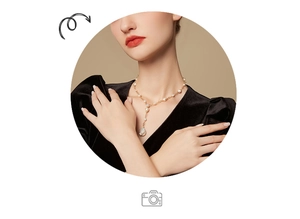 Close-up of baroque freshwater pearl necklace with gold pendant on black velvet dress