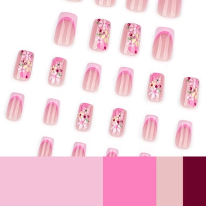 Pink French tips and floral press-on nails with cherry patterns for a fresh aesthetic