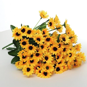 Close-up of artificial yellow sunflowers with silk fabric petals and green leaves