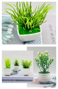 Detailed view of artificial green succulents in white pots with faux moss and杂志 prop