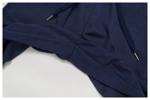 Detail of navy blue sweatpants featuring high-quality metal-tipped drawstrings and stitching