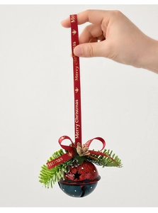 Detail of Christmas bell ornament with metal star cutouts, pine needles, and Merry Christmas ribbon