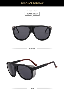 Detail view of black pilot sunglasses with matte frames, gray lenses and side shields