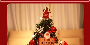 Close-up of mini Christmas tree desktop ornament with red balls and festive cards