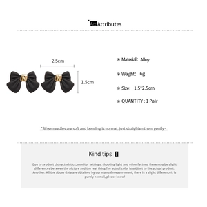 Detail specifications of black bow earrings with gold accents and silver needle size info
