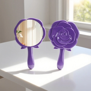 Detail of purple rose handheld mirrors showing carved floral design and mirror surface