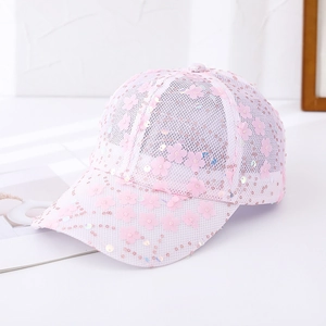 Detail of pink mesh baseball cap featuring decorative fabric flowers and shiny sequins