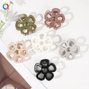 Macro view of six-piece hollow flower hair claw clips in assorted glossy resin colors