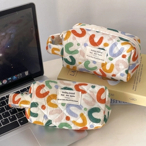 Quilted cotton travel makeup bag set with colorful retro abstract comma print and zipper