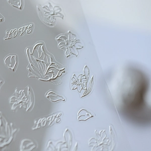 3D embossed nail stickers featuring white butterfly and flower designs with LOVE lettering