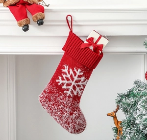 Detail of red knit Christmas stocking with white snowflake pattern and soft faux fur trim