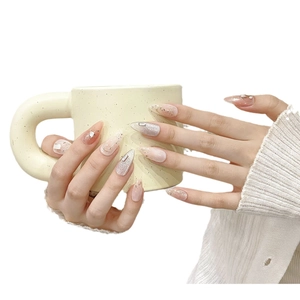 Pink and white gradient almond press-on nails with cat-eye effect and tiny rhinestones