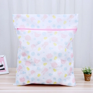 Detail of white mesh laundry bag with pink bear and bunny prints and zipper protector
