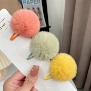 Detailed view of pink, green, and yellow fluffy rabbit fur mini hair clips for girls