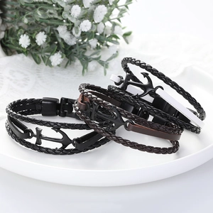 Set of three retro anchor multilayer leather bracelets in black and brown on white plate