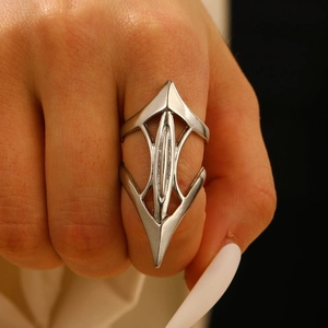 Close-up of long geometric hollow silver ring showing modern punk design on finger