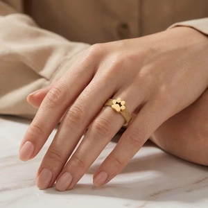 Macro shot of gold mesh band ring featuring a minimalist cutout paw print design