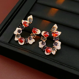 Detailed macro view of U-shaped earrings with colorful gemstones and brilliant zircons