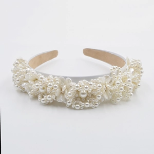 Detailed view of luxury baroque headband with clusters of white pearls and flower petals