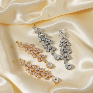 Elegant cubic zirconia teardrop tassel earrings in gold and silver finish on silk fabric