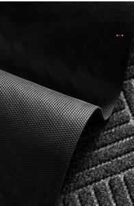 Macro detail of black natural rubber backing with anti-slip texture for door mats