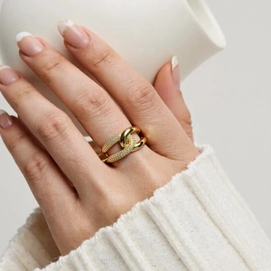 Layered 18K gold plated multi-line ring with micro-pave cubic zirconia on model's hand