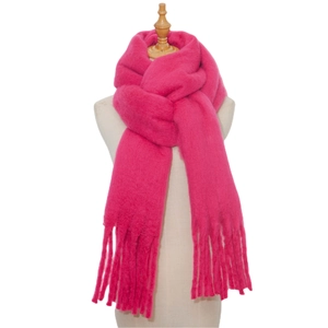 Close-up of soft pink mohair scarf showing thick knit texture and fringe tassel detail
