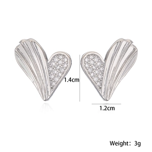 Detail of silver heart earrings showing dimensions 1.4cm by 1.2cm and 3g weight