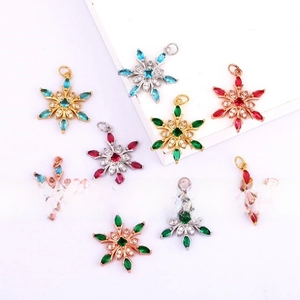 Macro shot of 18k gold plated snowflake pendants with colorful zircon inlay crystals