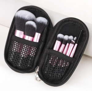Pink makeup brush set stored in a black mesh zipper pouch with organized interior mesh pockets
