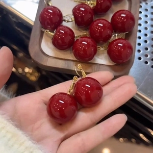 Elegant deep red resin cherry hoop earrings with golden metal hooks for women