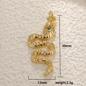 Macro shot of 30mm gold snake pendant with green gem eyes and sparkling zircons