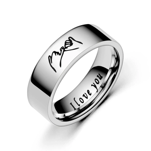 Macro detail of silver titanium steel ring with hand-holding engraving and I love you text
