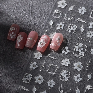3D floral embossed nail art stickers with white flowers and pearls on pink gradient nails