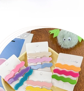 Close-up of wavy macaron candy color acetate hair clips set on fashion jewelry cards
