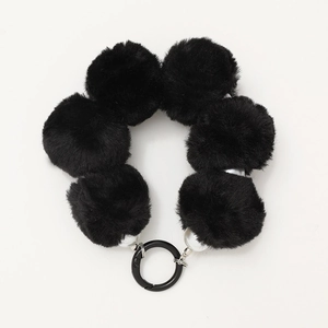 Handmade black plush ball beaded phone wrist strap with metal spring clasp on white background