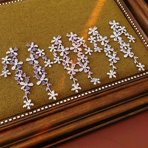 Detailed macro view of sparkling zircon flower tassel earrings in purple, pink and white