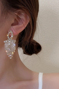 Luxurious long tassel earrings with high-density crystals on a gold base shown on model