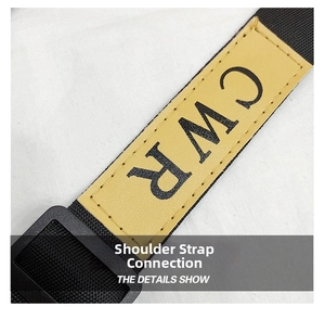 Close-up of black nylon strap with yellow leather patch featuring CWR logo branding