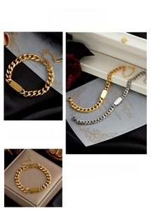 Detailed macro view of gold and silver cuban chain bracelets with flat rectangular metal tags