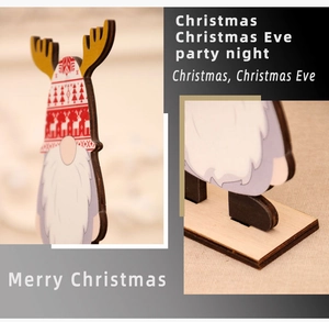 Detail view of a wooden Christmas gnome ornament with reindeer antlers and red hat