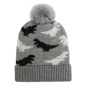 Detail of baby dinosaur knit beanie featuring gray yarn texture and fluffy pompom top