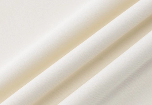 Macro shot of off-white chiffon fabric showing fine texture and elegant drape