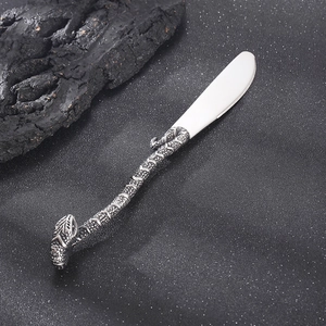 Vintage stainless steel snake handle butter knife with creative serpent design on black background